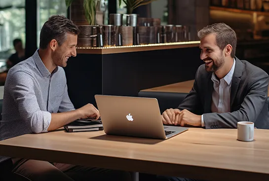 Company members looking at laptop